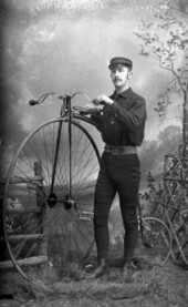 Laurie A. Perkins with a Penny-Farthing bicycle.