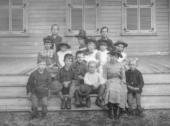 Teacher and her students on steps.