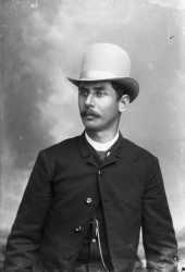 Mustached man in a bowler hat.
