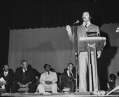 Men watching Civil rights leader Jesse Jackson delivering a speech in an auditorium - Tallahassee, Florida.