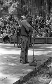 Unidentified musician playing the guitar during a performance at the 1970 Florida Folk Festival - White Springs, Florida.
