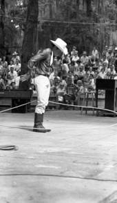 View of trick roper Danny Coflin performing at the 1970 Florida Folk Festival - White Springs, Florida.