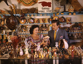John M. Gonatos in his curio shop viewing shells with assistant Niki Vasilikis in Tarpon Springs, Florida.