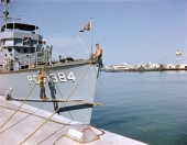Sailors painting the USS Eufaula (PCS-1384) docked at the naval station in Key West.