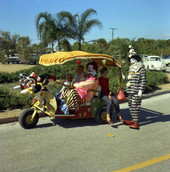 Clowns with children during the St. Boniface Episcopal Church fair in Sarasota, Florida.
