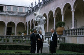 Dominican Republic ambassador Jose A. Bonilla Atiles speaking with men in the courtyard at the John and Mable Ringling Museum of Art in Sarasota, Florida.