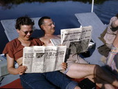 Mabel and Archie aboard the shantyboat "Lazy Bones," reading of a snowstorm in the northeast U.S.