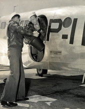 Naval Photography School students loading aerial camera on to plane at NAS Pensacola.