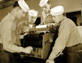 Naval Photography School instructor showing students how to use equipment at NAS Pensacola.