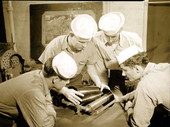 Naval Photography School instructor showing students how to put film on the spool at NAS Pensacola.