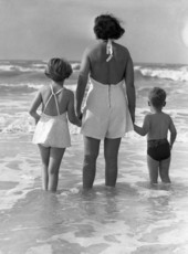 Photographer's wife and children entering the Gulf of Mexico surf.
