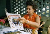 Photographer's wife, Lois Foley Steinmetz, reading a copy of New Horizons in Nassau, Bahamas.