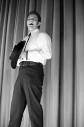 View of a magician on stage during a magic show at the Sarasota Jr. High School.