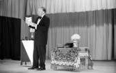 View showing a magician on stage during a magic show at the Sarasota Jr. High School.