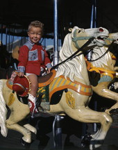 Boy on a merry-go-round in Taos, New Mexico.
