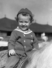Portrait of John Ringling North II on his pony.