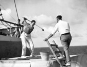 Driving golf balls from ship during cruise.
