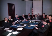Business meeting with all men wearing azaleas in their lapels.