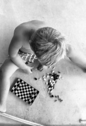 Boy with a travel chess/checker set in Sarasota, Florida.