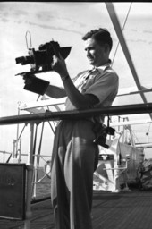 Photographer Joe Steinmetz taking a photograph on board a ship traveling to Guatemala.