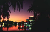 Evening lakeside view of Orlando skyline during sunset.