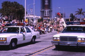 Grand Marshal on horseback following police escort during the Gasparilla Carnival parade in Tampa.