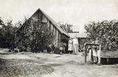 Koreshans standing next to a pioneer house in Estero, Florida.