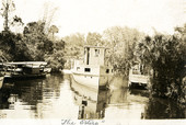 Postcard showing the Koreshan Unity boat "The Estero" on the river.