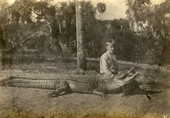 Koreshan Julius Koester sitting next to an alligator in Estero, Florida.