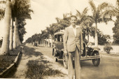 Portrait of Harry Manley on an avenue with palm trees.