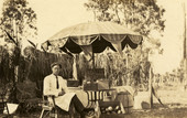 Postcard of Koreshan Harold Moreland at a roadside stand.