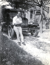 Koreshan Raymond Trebell leaning against car.
