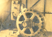 Alfred Christensen standing next to new motor and switchboard inside power plant at the Koreshan Unity in Estero, Florida.