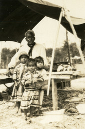 Portrait of Seminoles at camp on the Tamiami Trail.