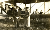 Portrait of Koreshan Hattie Englert and her father standing next to an airplane.