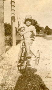 Koreshan girl on a tricycle.
