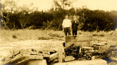 Koreshan men by the mausoleum wreckage at Ft. Myers Beach on Estero Island following a hurricane.