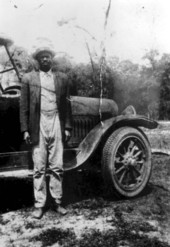 Charlie H. Moore beside car - Lovett, Florida