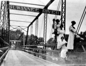 Group posed on railing of Hillman Bridge - Ellaville, Florida