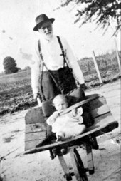 James Madison Groover rolling grandson Wyche Groover in wheelbarrow