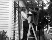 Men installing bell at church - Cherry Lake, Florida