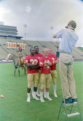 Photographer takes picture of FSU football players with Chief Osceola and Renegade - Tallahassee, Florida