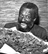 Wally "Famous" Amos poses with his famous cookies - Tallahassee, Florida.