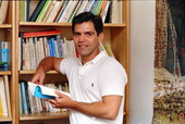 Author Roberto Fernandez poses with his books - Tallahassee, Florida