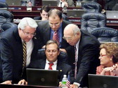 Members huddled around Florida State Representative Paige Kreegel during a short break on the House floor in Tallahassee.