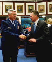 Representative Ron Reagan, R-Sarasota, right, greeting Florida National Guard Major General Douglas Burnett on the House floor in Tallahassee, Florida.