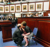 Rep. Baxter Troutman getting kissed after placing an engagment ring on the finger of his fiancee Becky Carney.