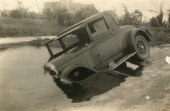 Car blown into damaged road during the 1926 hurricane in Miami Beach.