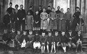 Students posed in front of school building