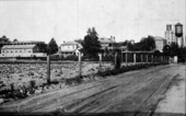 Dirt road with buildings in background - Chattahoochee, Florida.
